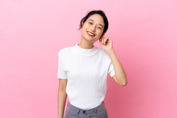 Young Vietnamese woman isolated on pink background laughing