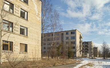 Fototapeta na wymiar Abandoned white brick multistorey houses. Forgotten, abandoned ghost town Skrunda, Latvia. Former Soviet army radar station.