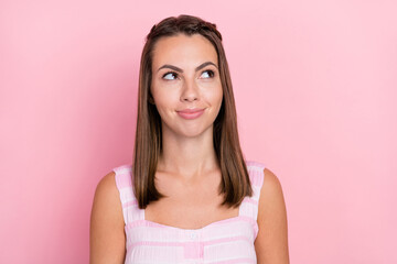 Photo of young attractive girl dreamy wondered plan look empty space isolated over pink color background