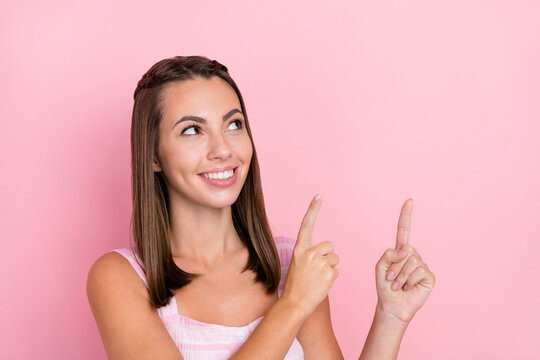 Photo of young beautiful woman point fingers empty space recommed advise follow ads isolated over pink color background