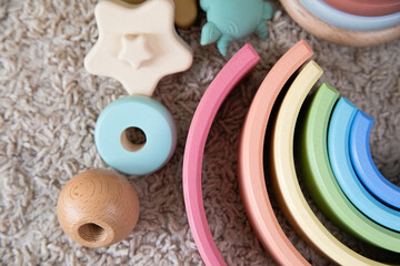 multi-colored children's toys made of wood lie on the floor