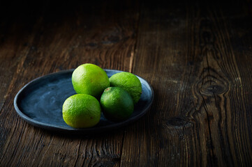 Lime Citrus Fruits on wooden table. Lime background. Free space for text