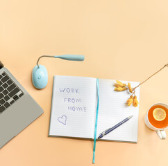 flatlay business, work from home, freelance, copywriting, top view laptop, notebook with work from home note and cup of tea on beige background. 