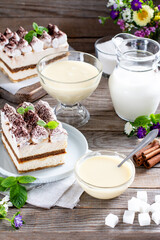 Dessert Tiramisu with whipped cream. Sweet cake with condensed milk