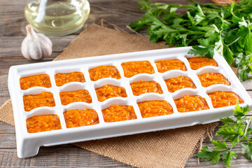 Frozen vegetable puree and ice tray. Life hacks, simple way to store vegetables