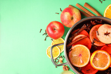 Concept of cooking  mulled wine on green background
