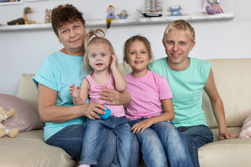 Grandmother sits with grandchildren