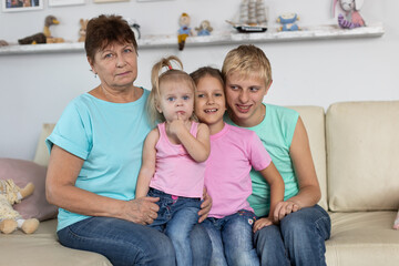 Grandmother sits with grandchildren