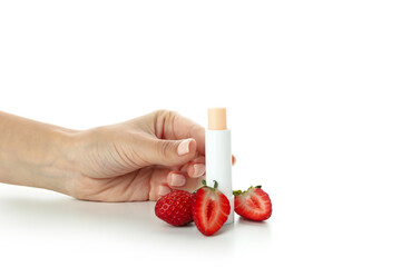 Female hand and hygienic lipstick with strawberry, isolated on white background