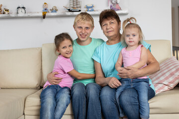 Grandmother sits with grandchildren