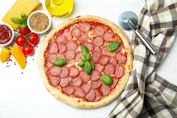 Concept of tasty food with Salami pizza on white wooden background