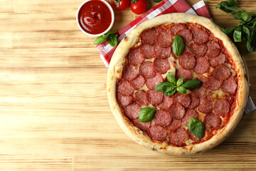 Concept of tasty food with Salami pizza on wooden background
