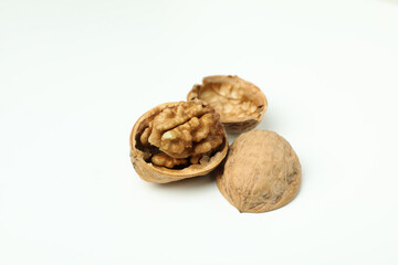 Walnuts with nutshell on white background, close up
