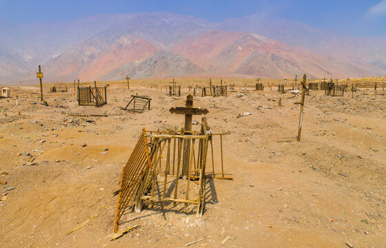 Dilapidated graves at a historic cemetery of the ghost-town of Gatico (Cementerio de Gatico) from the nitrate era in the Atacama desert in north Chile