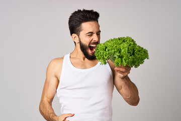 bearded man in white t-shirt lettuce leaf vegetables healthy food