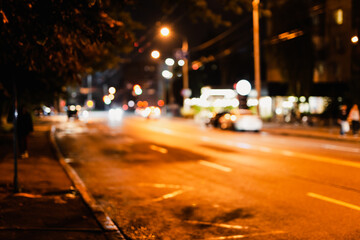 Fototapeta na wymiar Blurred background of city street at night
