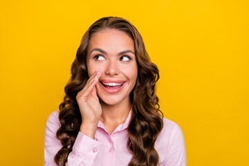 Photo of cunning young brunette lady tell secret wear pink shirt isolated on yellow color background