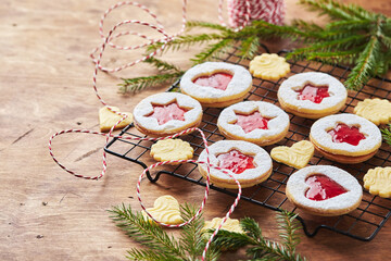 Classic Linzer Christmas Cookies with raspberry or strawberry jam on wooden table