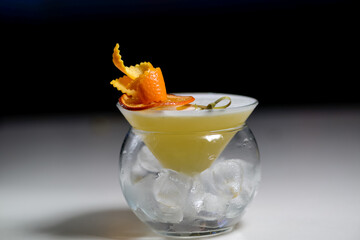 Fototapeta na wymiar alcoholic cocktail decorated with orange zest 