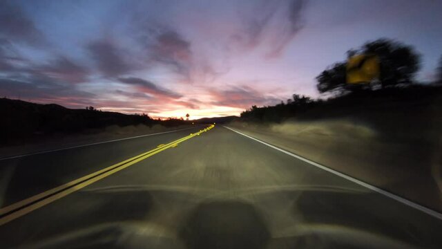 Desert road curve dawn driving on Fort Tejon Road near Palmdale and Littlerock California.