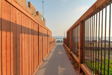 Concrete pathway in the middle of fences at Oceanside, California