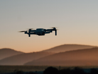 Fototapeta na wymiar Drone flying at sunset. Drone photography or cinematography