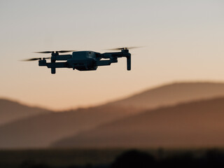 Drone flying at sunset. Drone photography or cinematography