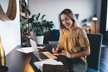 European girl learning online on laptop at home