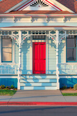 Front porch exterior with red front door at Oceanside, California