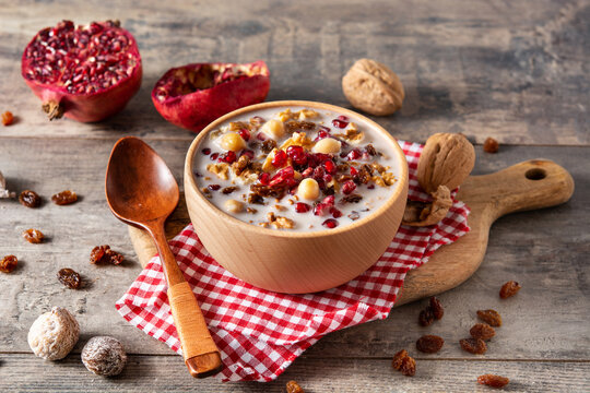 Traditional Turkish Noah's pudding in bowl on wooden table	