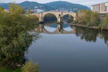 Fototapeta premium View of the Miño river and the Roman bridge in Ourense, Galicia. Spain.