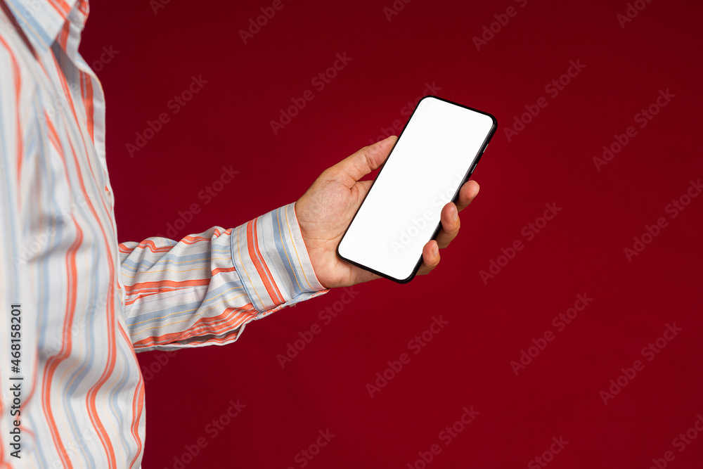 Aufkleber technology, communication, and advertising concept. close-up of hand holding a smartphone with blank