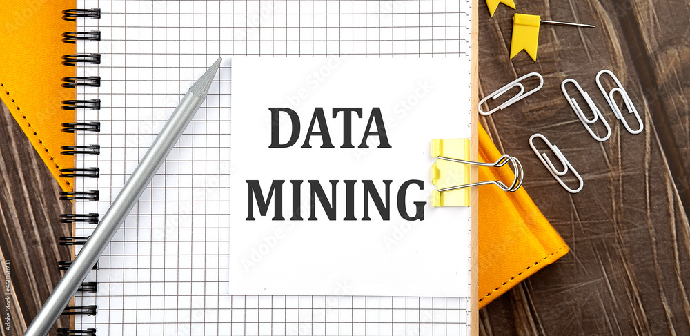Poster data mining text on a sticker on the notebook, wooden background