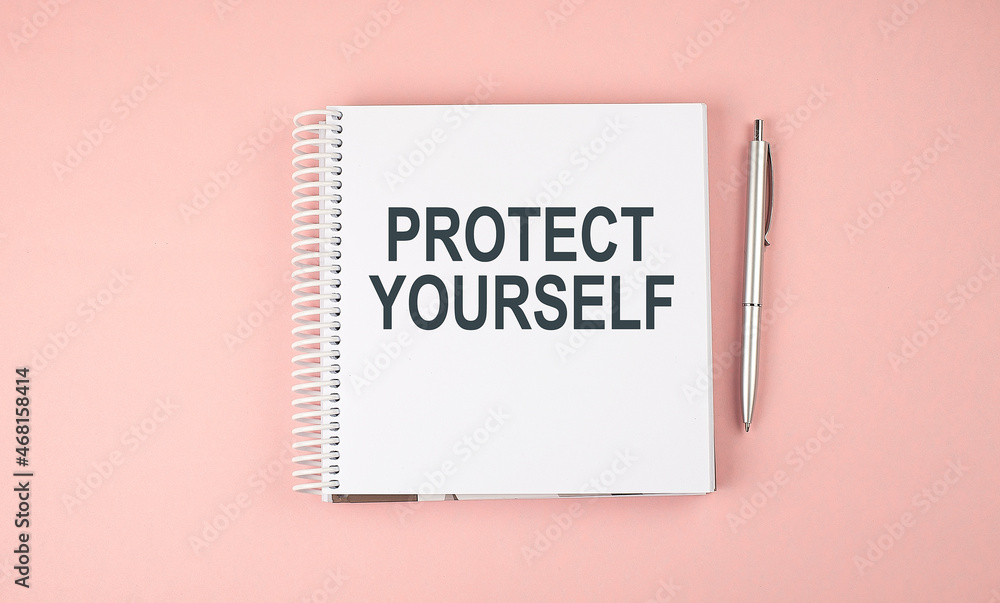 Aufkleber protect yourself text on notebook with pen on the pink background