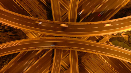 Aerial drone long exposure night photo of urban elevated road junction and interchange overpass in...