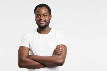 Black man laughing while posing with arms crossed