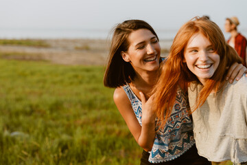 Fototapeta premium Young white friends hugging and making fun together