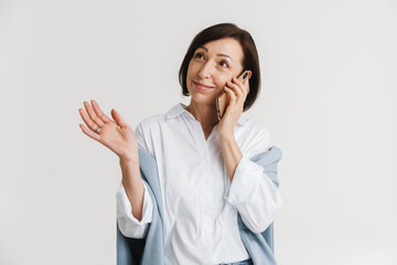 European mature woman gesturing and talking on mobile phone