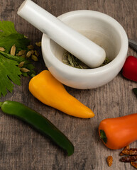 closeup of several bell peppers leaning on a wooden table