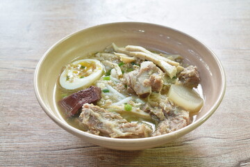 Vietnamese rice noodles or Pho with slice sausage and pork bone soup on bowl