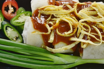 fresh Chinese spring roll made from flour wrapped tofu and pork with bean sprout dressing sweet red gravy sauce on plate