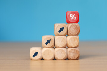 wooden cube block with arrow icon pointing towards percentage symbol icon, Finance and Mortgage Concepts interest rate