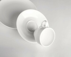 White cup and saucer. The illusion of falling dishes.