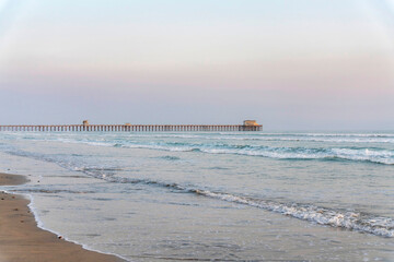 Empty beach with pier and sandy shore at Oceanside in California