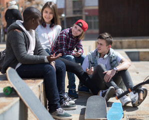 group of modern teens chatting in the yard
