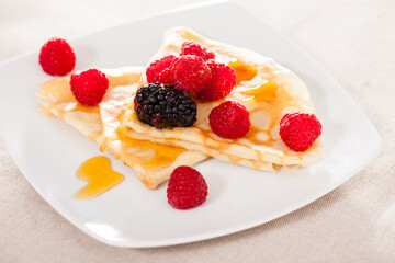pancakes with raspberries, blackberries and honey