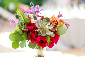 Bridal bouquet. Beautiful Bouquet of flowers of roses, succulents, orchids and thistles. Wedding decorations. Soft selective focus.
