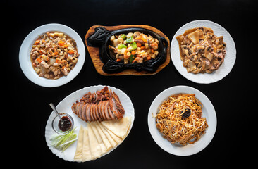 Group of different Asian dishes of baked Peking duck, Chow Mein noodles in iron pan, shrimp with vegetables. chicken stew almonds, carrots and pasta. Flat lay .