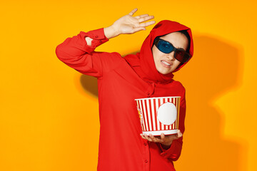 woman in red hijab 3d glasses technology watching movie popcorn yellow background