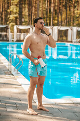 Male lifeguard warning visitors about emergency situation